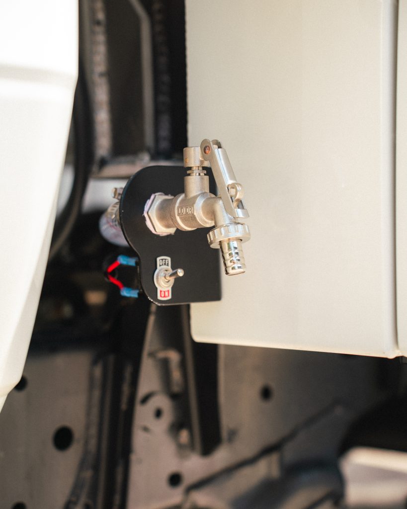 Water tap connected to the water tank fitted and stored underneath the tray