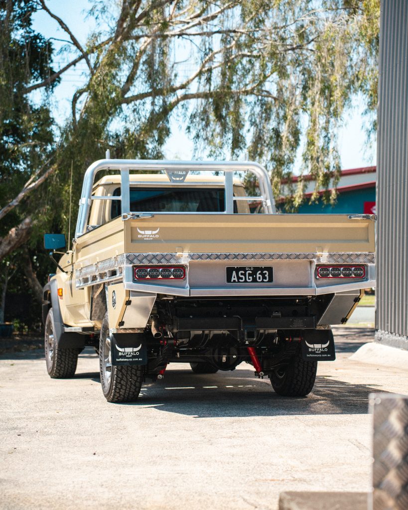 Taupe 79 Series Landcruiser with Buffalo Tray with and Semi Departure Toolboxes behind the wheels. Under the tray we have an 85lt Diesel Storage Tank and the spare tyre.